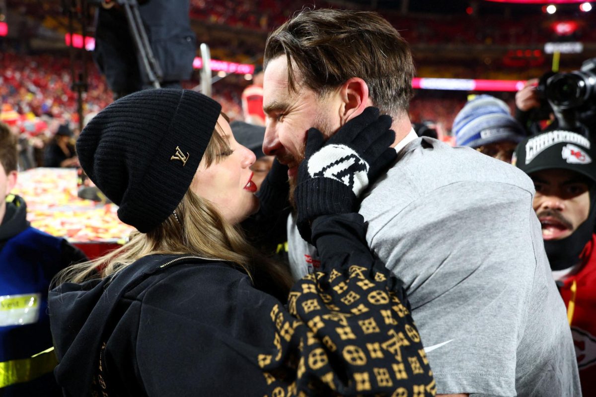 Jan 26, 2025; Kansas City, MO, USA; Recording artist Taylor Swift  and Kansas City Chiefs tight end Travis Kelce (87) react after the AFC Championship game against the Buffalo Bills at GEHA Field at Arrowhead Stadium. Mandatory Credit: Mark J. Rebilas-Imagn Images
