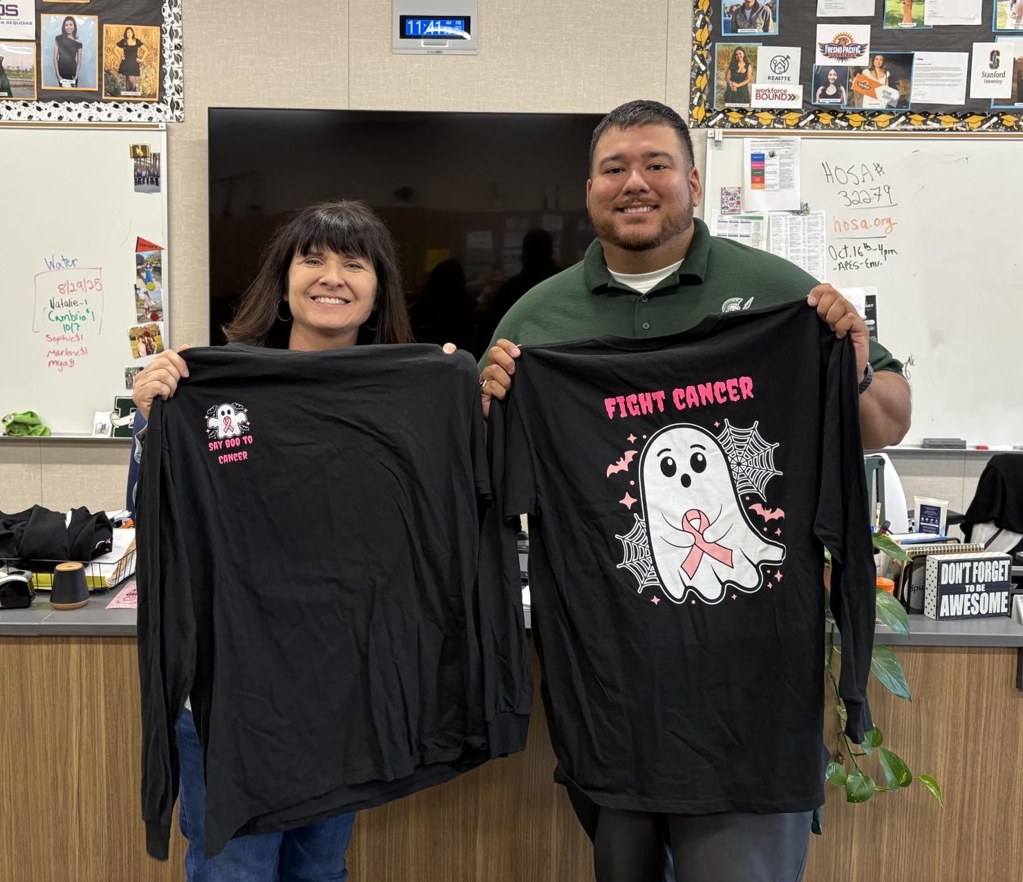 Mrs. Pennebaker and Mr. Delgado displaying this year's HOSA Pink Out t-shirts.  