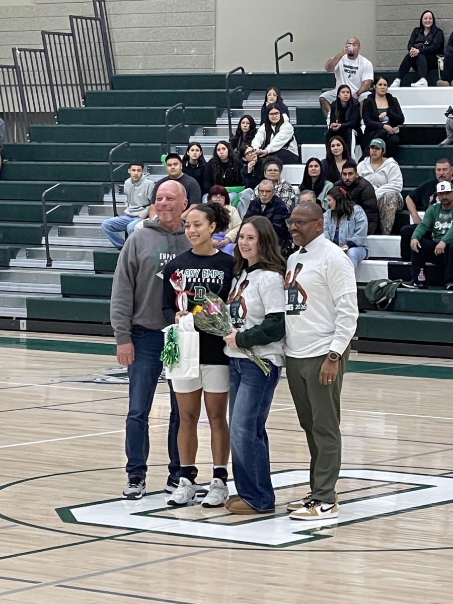 Kathryne Forbes (13, senior captain) being announced at senior night. Jeffery Harris (right), Kathryne Forbes (center right), Emilee Forbes  (center left), and Wesley Forbes (left) are supporting her.