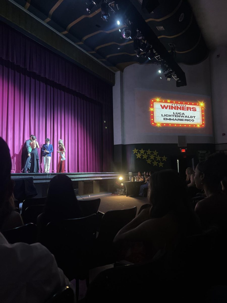 Luca Lichtenwaldt and Emmarie Rico accepting awards for Most Likely to Become a Millionaire